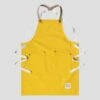 Yellow Children’s Apron -Home And Daily Necessities Store risdon and risdon childrens studio apron yellow cork grey background 600x600 1